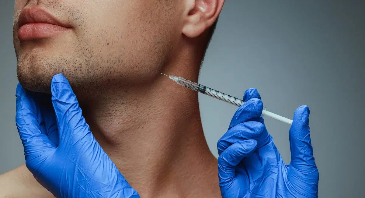 a guy receiving treatment with injections on the side of his face
