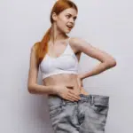 a stunning woman in loose pants showing her attractive waist