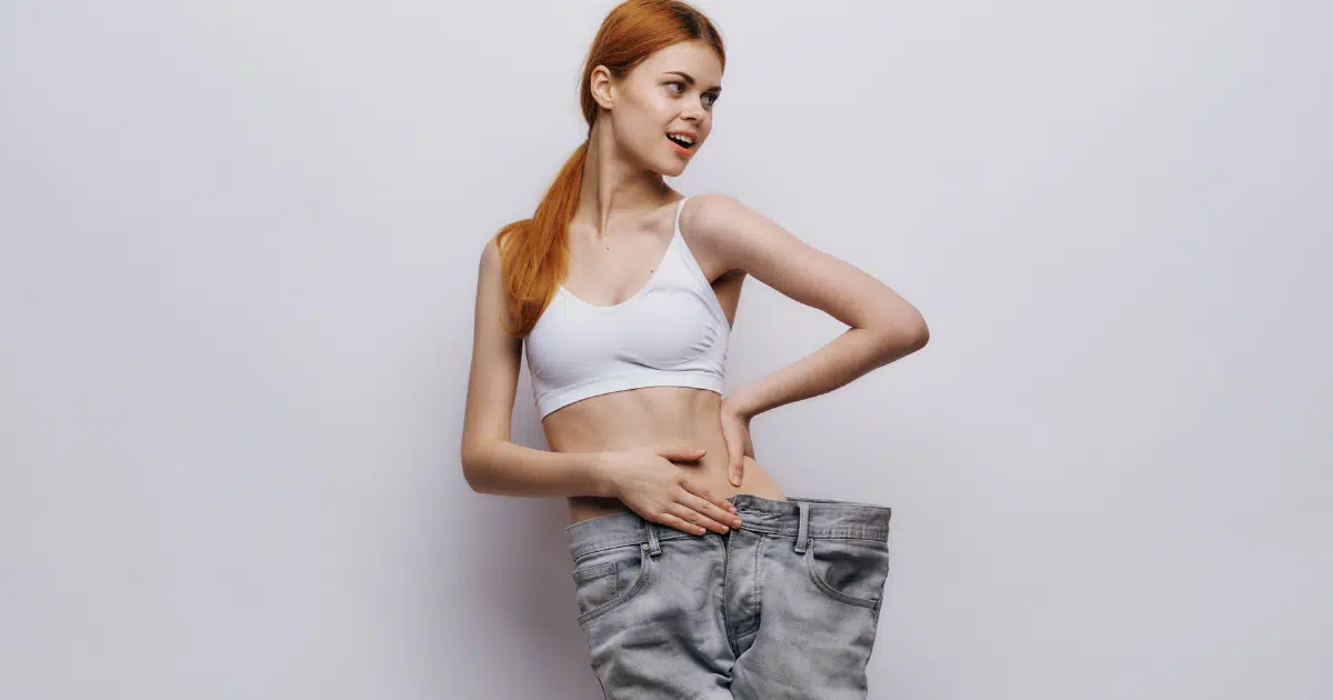 a stunning woman in loose pants showing her attractive waist