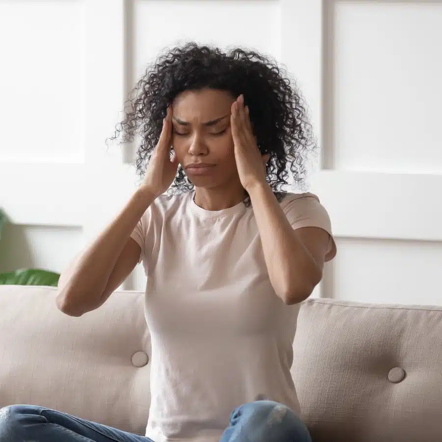 An image of a woman having a migraine that can be treated with Botox in Naples, Florida