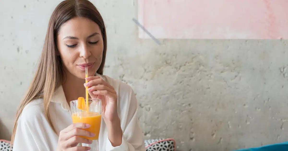 image of a woman drinking out of a straw