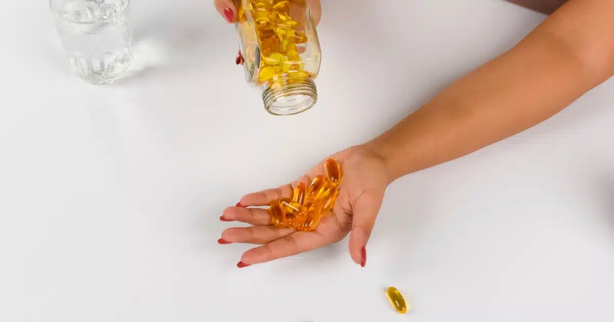 someone holding a handful of vitamins